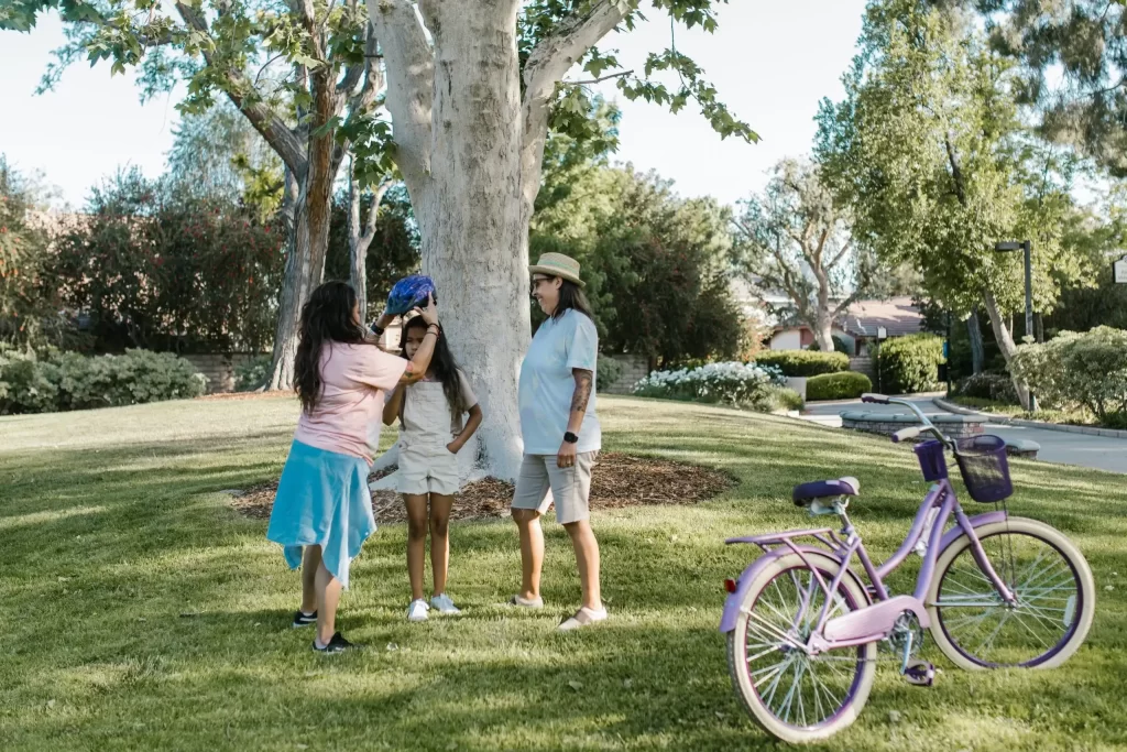 3 women playing next to an e-bike