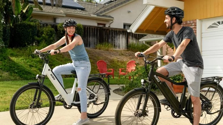 2 people happy while riding an e-bike