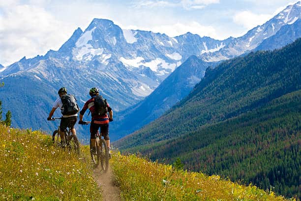 Two male mountain bike riders enjoy a cross country trail in British Columbia, Canada.