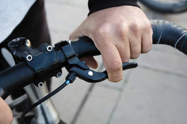 Hand on bike handle and brake
