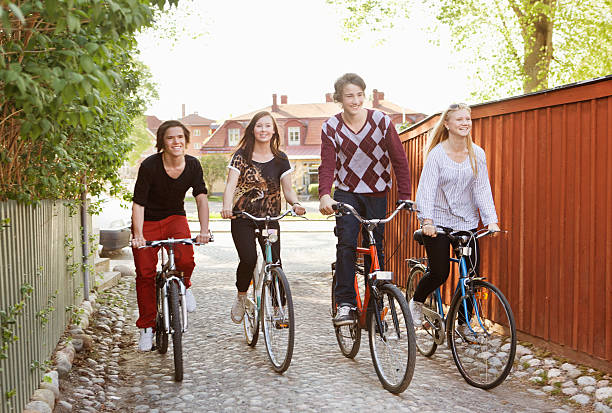 group of 4 teens riding an e-bike