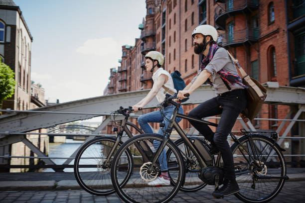 a couple riding an e-bike on a bridge in europe