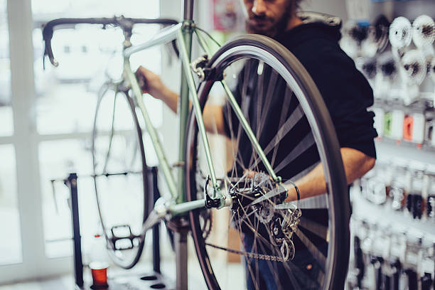 Young man working at the bicycle workshop
