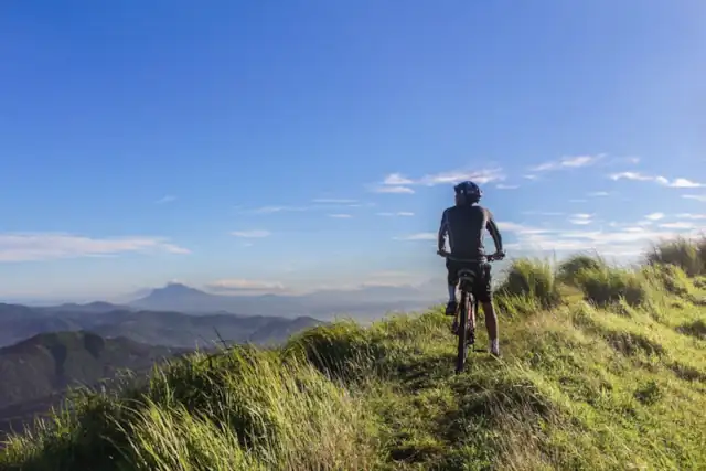 man on edge of cliff with ebike